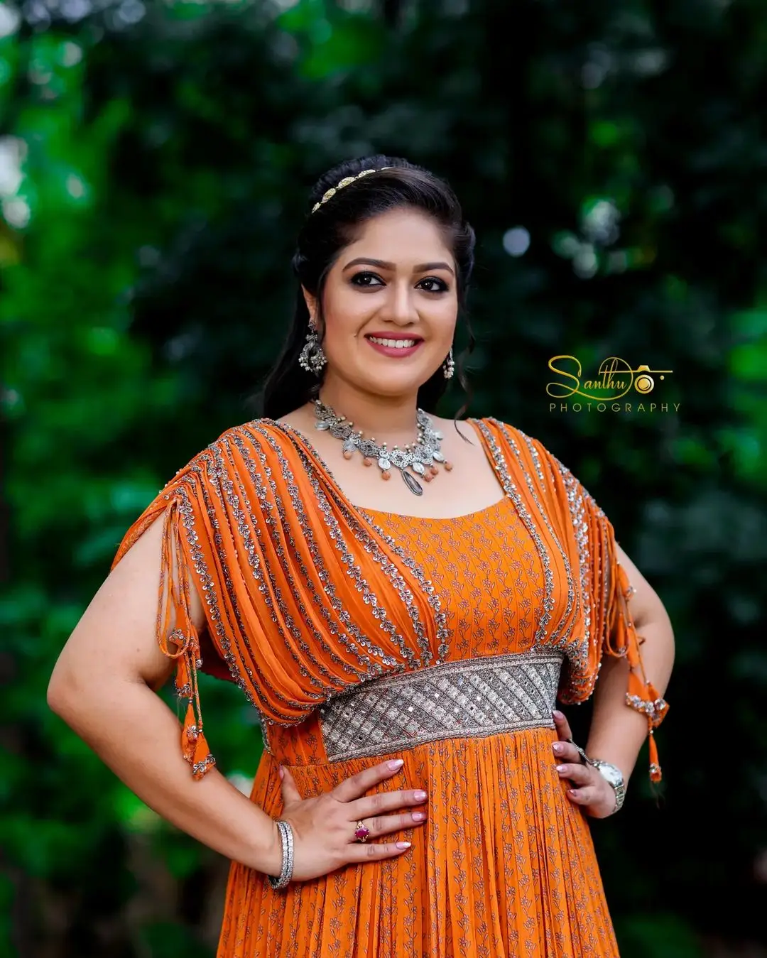 Meghana Raj Wearing Beautiful Earring Jewellery Orange Gown